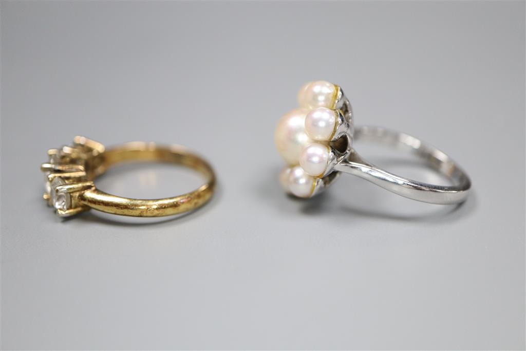 A modern 18ct white gold and cultured pearl cluster ring and a paste three stone ring